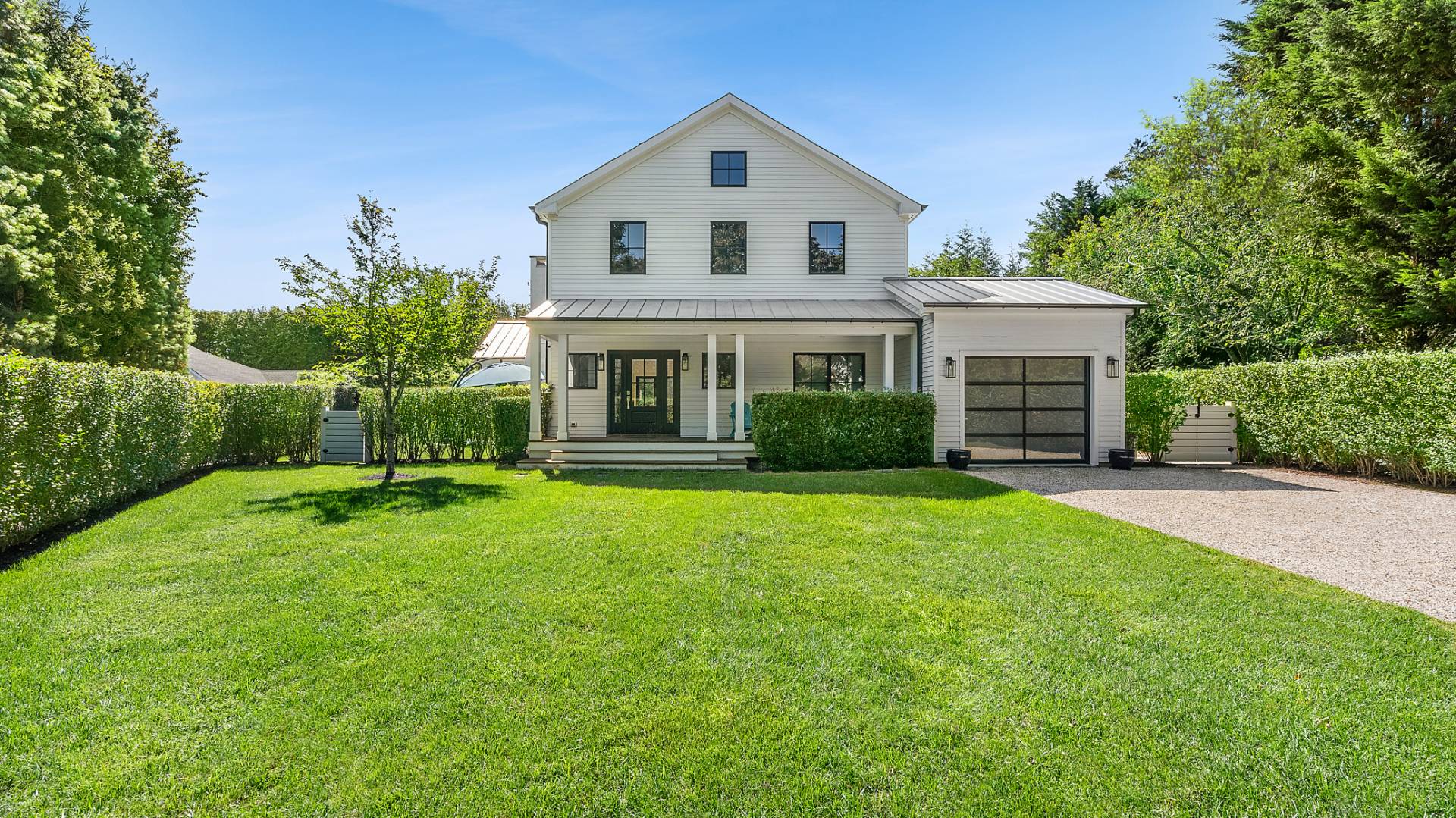 6 Inkberry Street East Hampton, NY 11937 - Photo 2 of 18 a front view of a house with a yard and porch