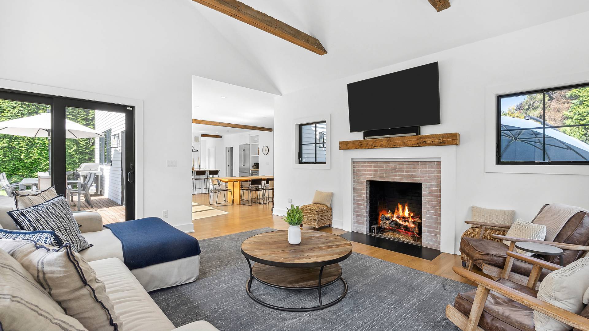 6 Inkberry Street East Hampton, NY 11937 - Photo 5 of 18 a living room with furniture a flat screen tv and a fireplace