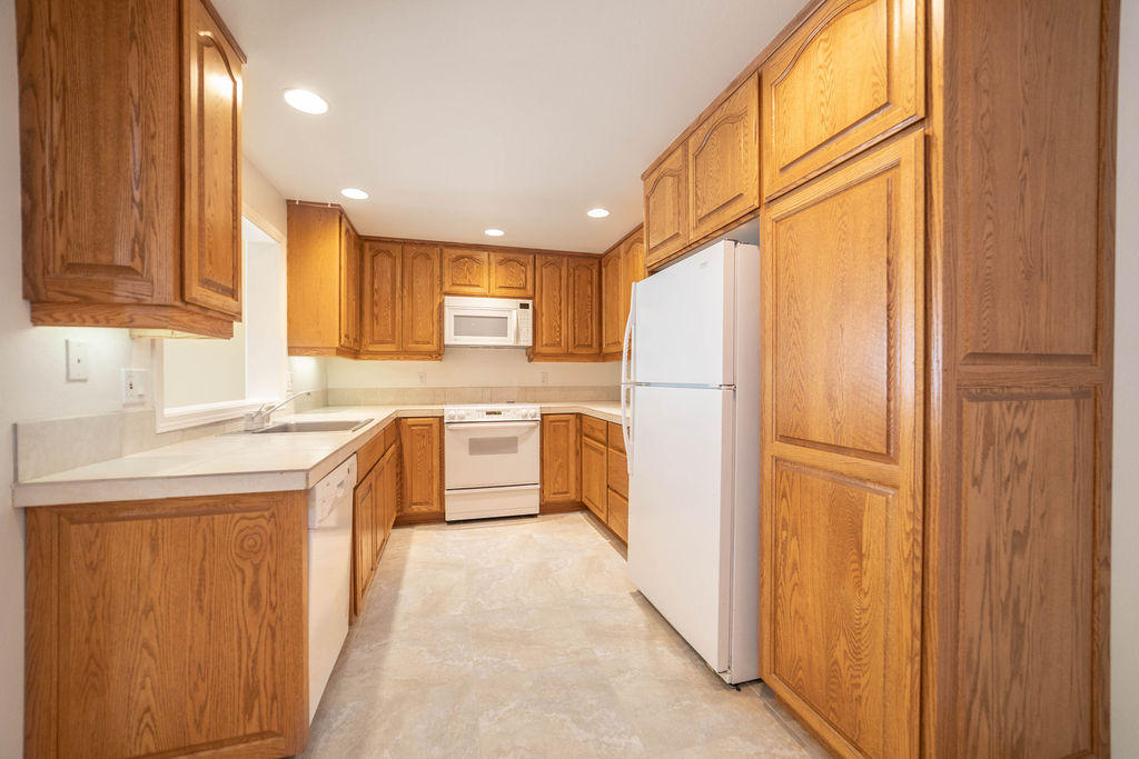16944 Downey Road Bend, OR 97707 - Photo 9 of 44 a kitchen with a refrigerator sink stove and cabinets