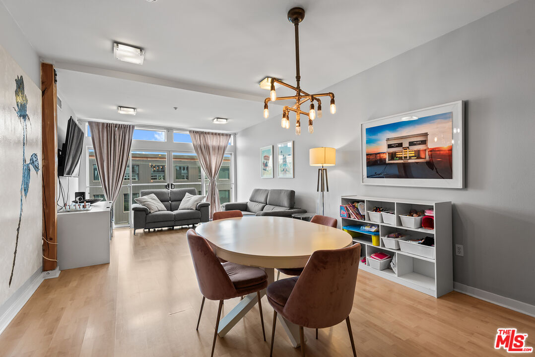 a dining room with furniture a chandelier and wooden floor