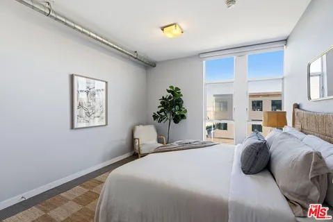 a bedroom with a bed and a potted plant