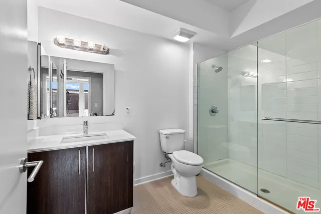 a bathroom with a toilet a sink and shower
