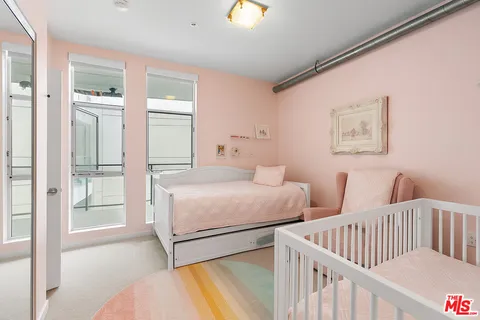 a bedroom with two beds and painted walls