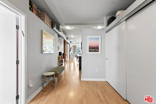a view of a hallway with wooden floor and staircase
