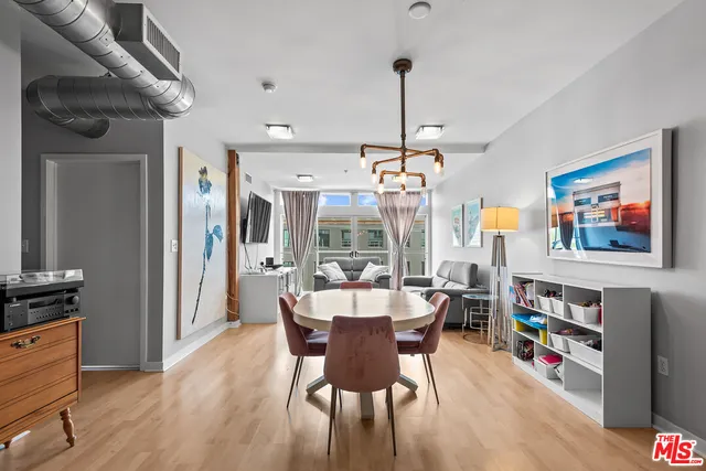 a view of a dining room with furniture large window and wooden floor