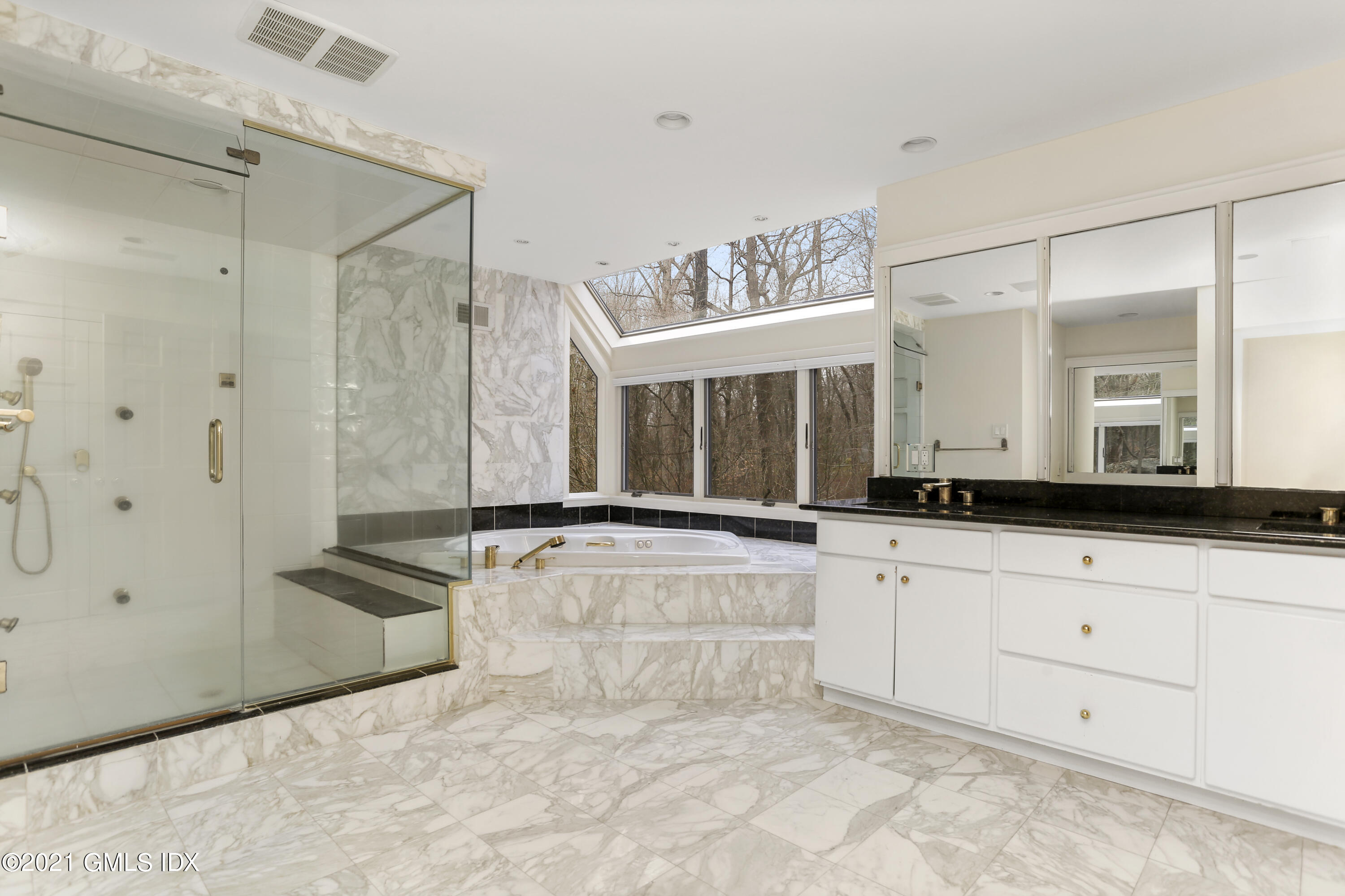 61 Sumner Road Greenwich, CT 06831 - Photo 11 of 19 a large bathroom with a large tub shower and sink