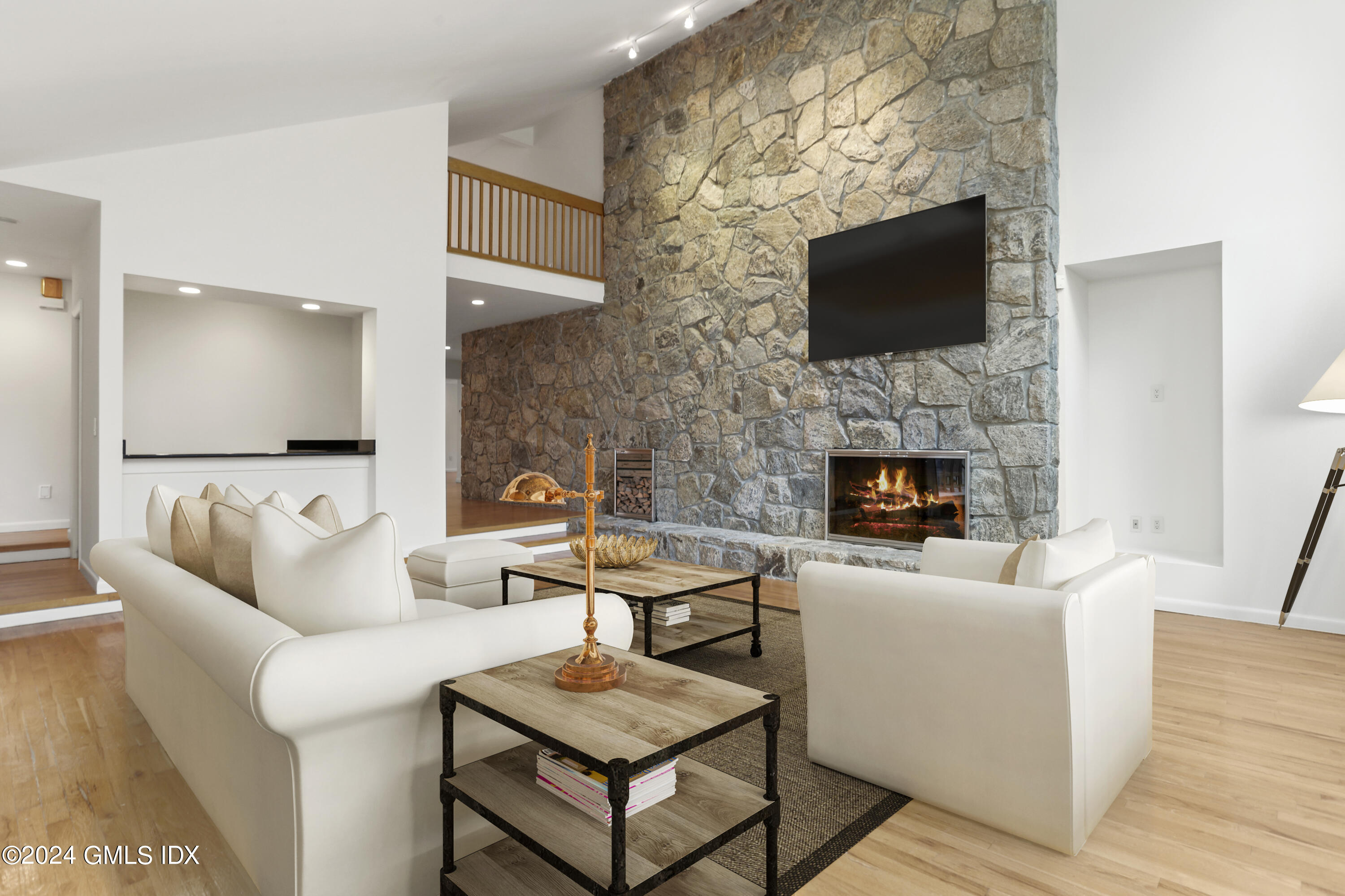 61 Sumner Road Greenwich, CT 06831 - Photo 3 of 19 a living room with furniture a flat screen tv and a fireplace