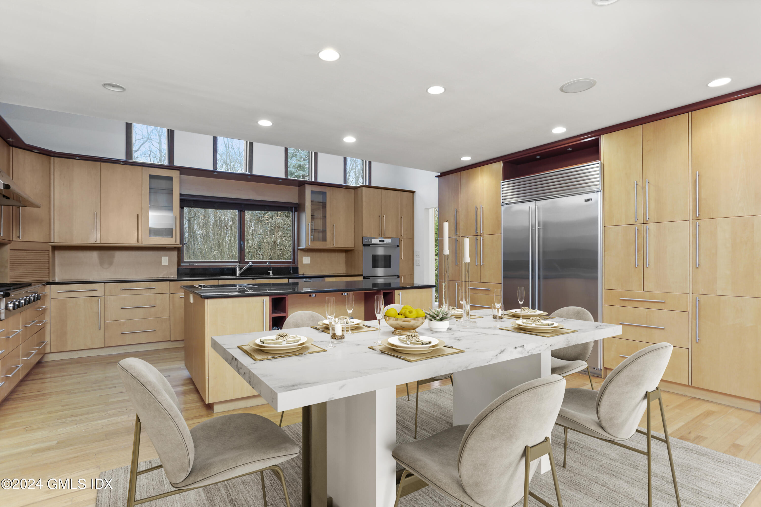 61 Sumner Road Greenwich, CT 06831 - Photo 7 of 19 a kitchen with a dining table chairs and sink
