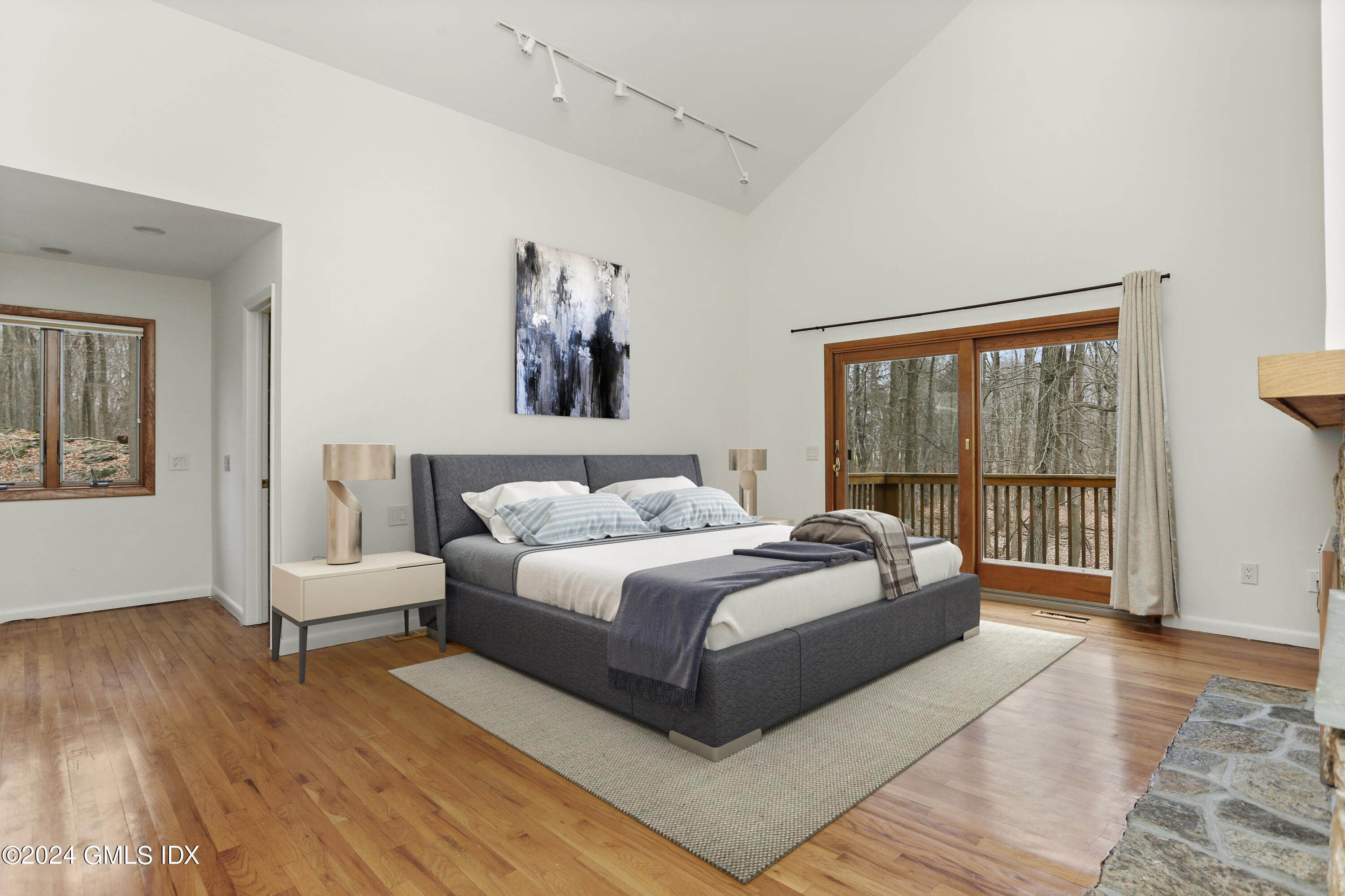 61 Sumner Road Greenwich, CT 06831 - Photo 10 of 19 a spacious bedroom with a large bed and a couch