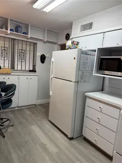a utility room with cabinets washer and dryer