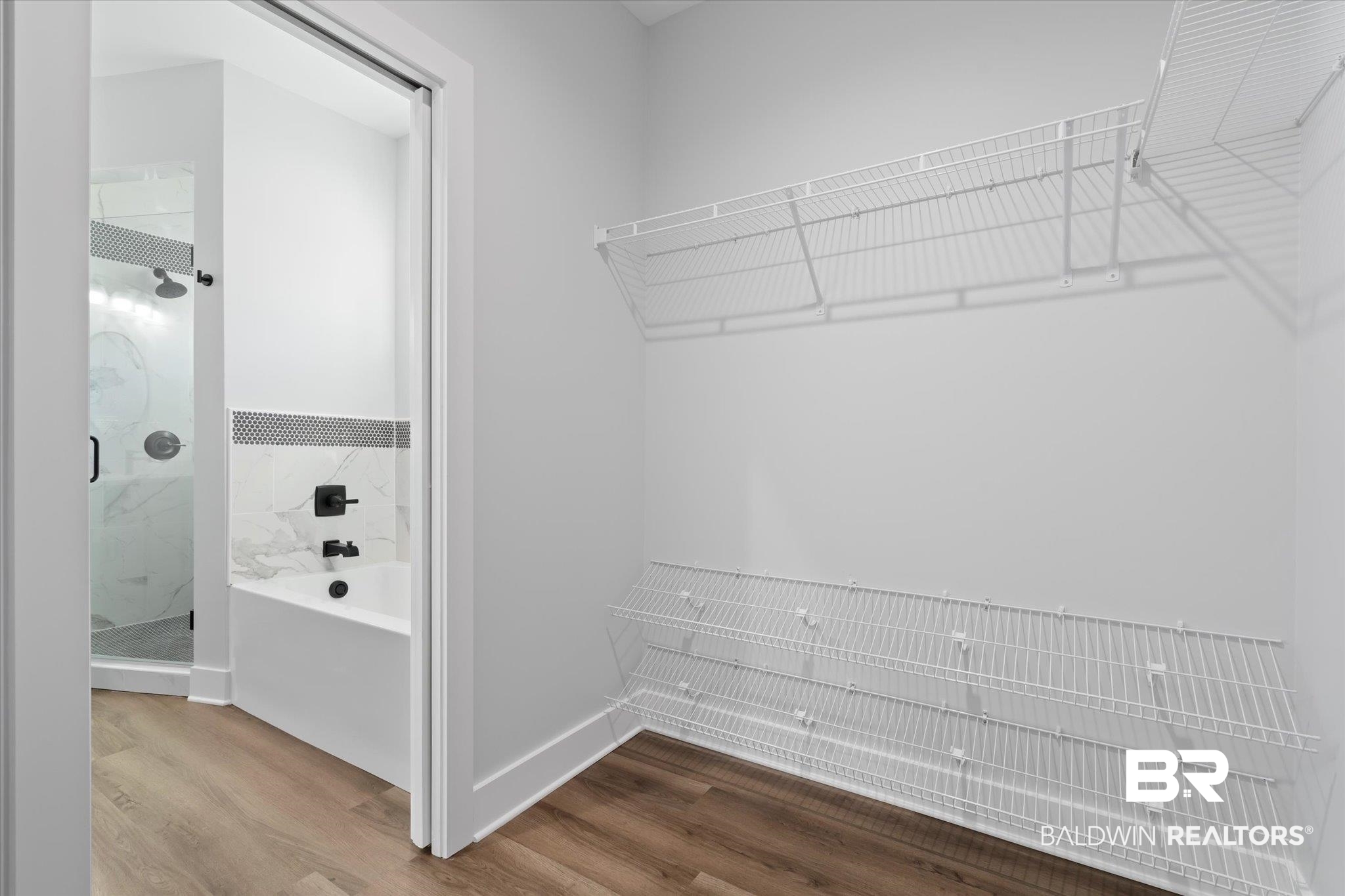 18151 Hoiles Street Robertsdale, AL 36567 - Photo 11 of 23 Walk in closet with wood-type flooring