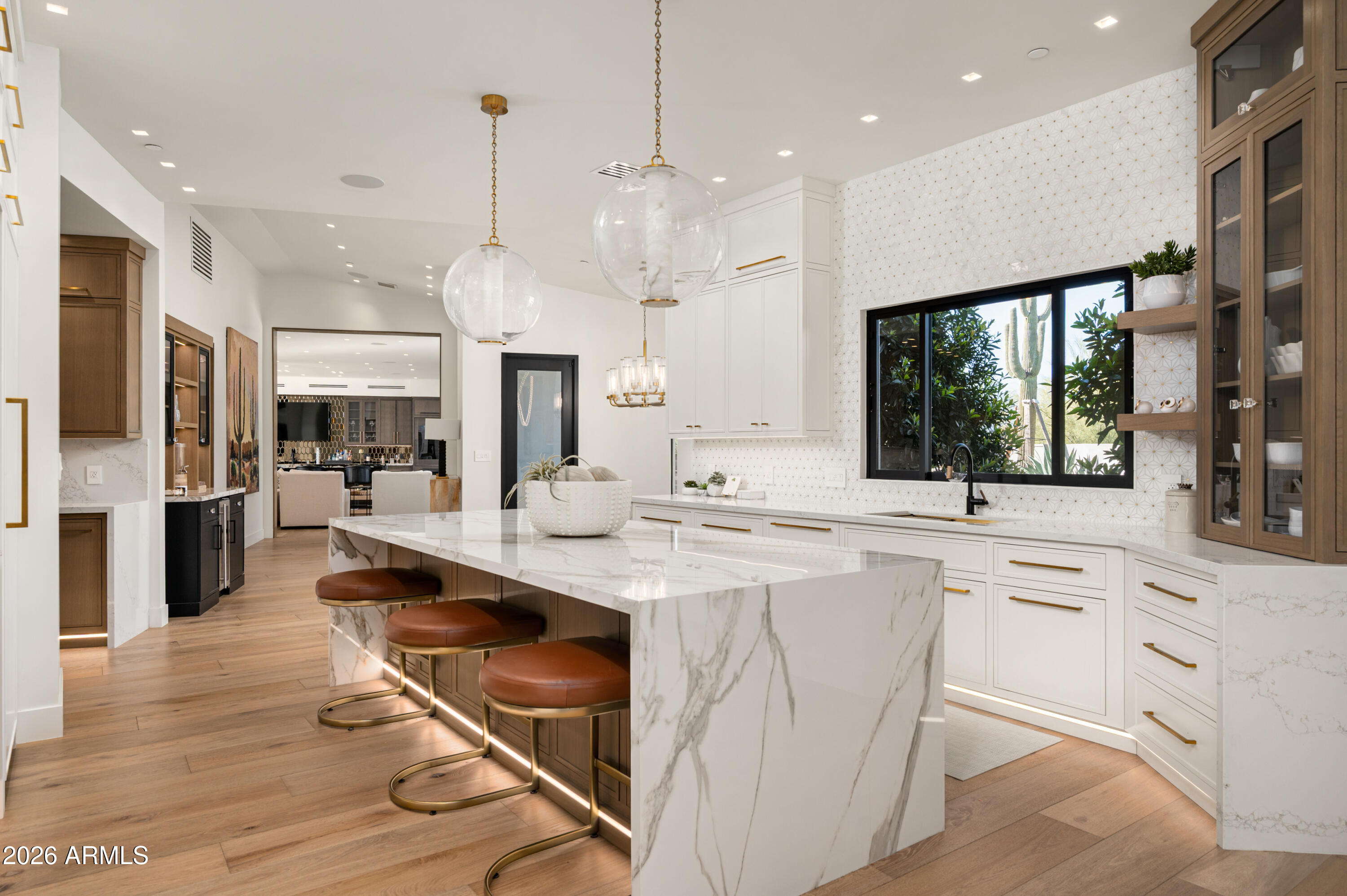 10040 East Happy Valley Road, Unit 13 Scottsdale, AZ 85255 - Photo 26 of 55 a large kitchen with kitchen island a large counter top space a sink stainless steel appliances and cabinets