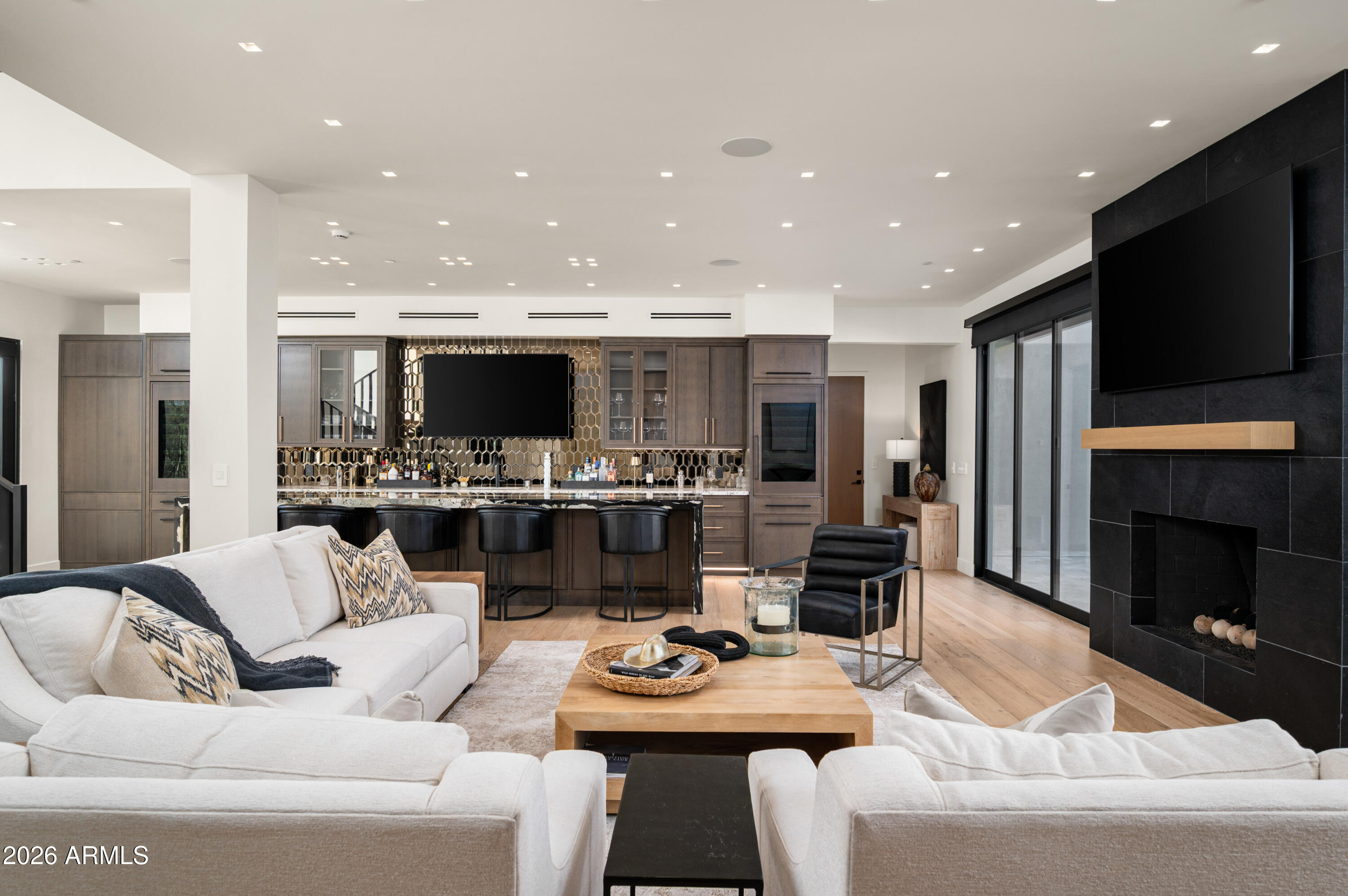 10040 East Happy Valley Road, Unit 13 Scottsdale, AZ 85255 - Photo 28 of 55 a living room with stainless steel appliances furniture a fireplace and a flat screen tv