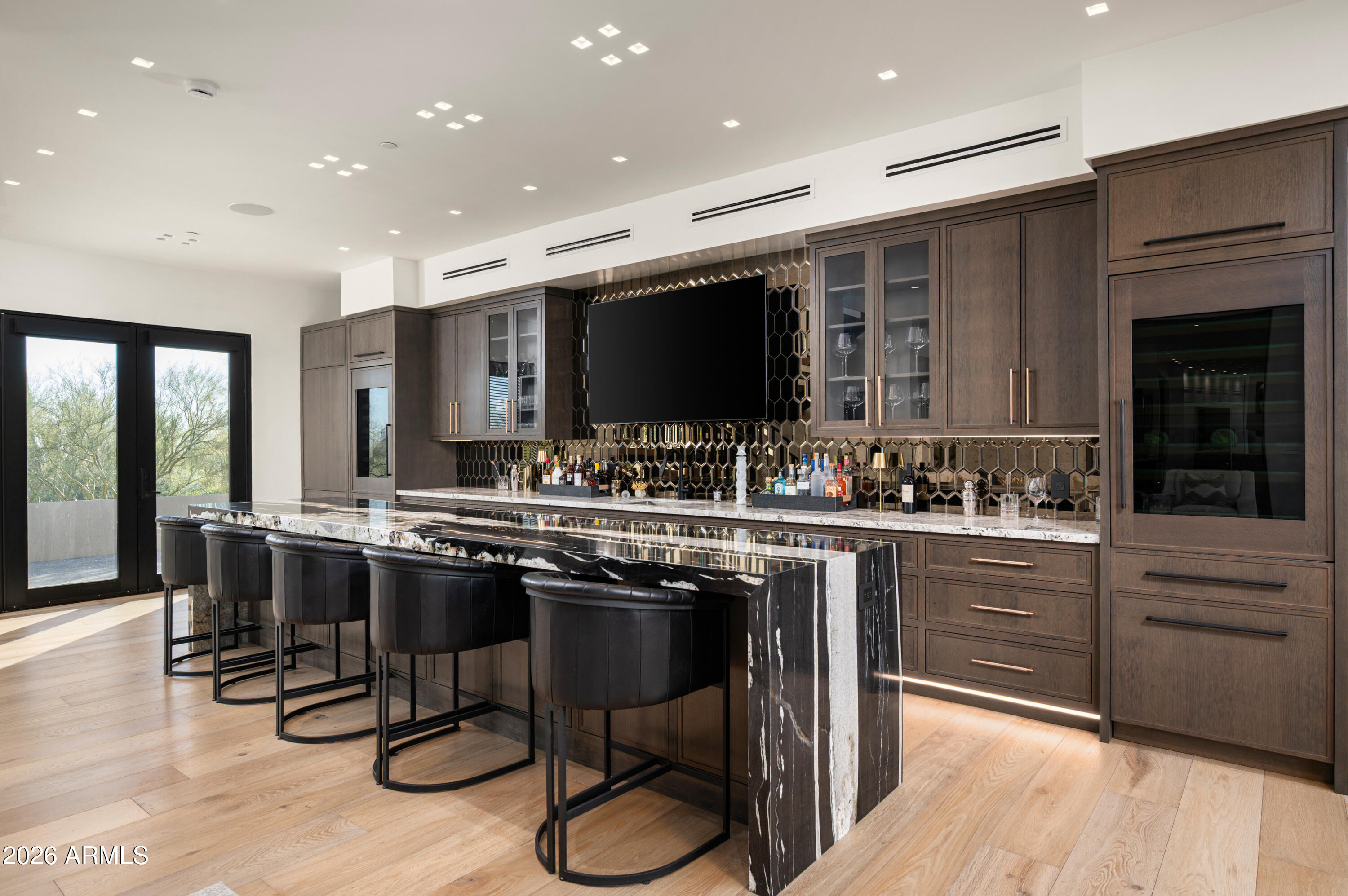 10040 East Happy Valley Road, Unit 13 Scottsdale, AZ 85255 - Photo 29 of 55 a kitchen with stainless steel appliances granite countertop a table chairs sink and cabinets