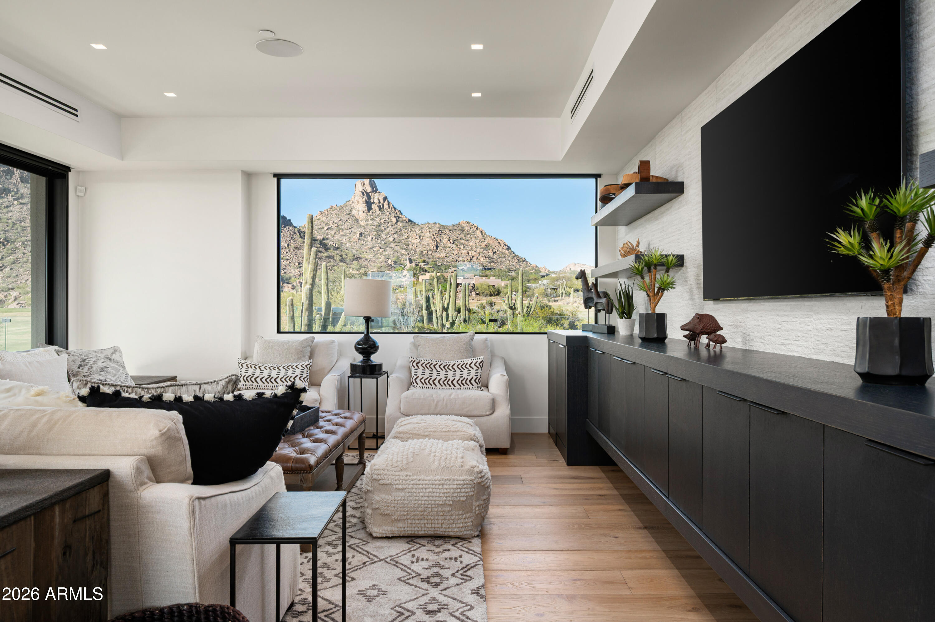 10040 East Happy Valley Road, Unit 13 Scottsdale, AZ 85255 - Photo 34 of 55 a living room with furniture a flat screen tv and a large window