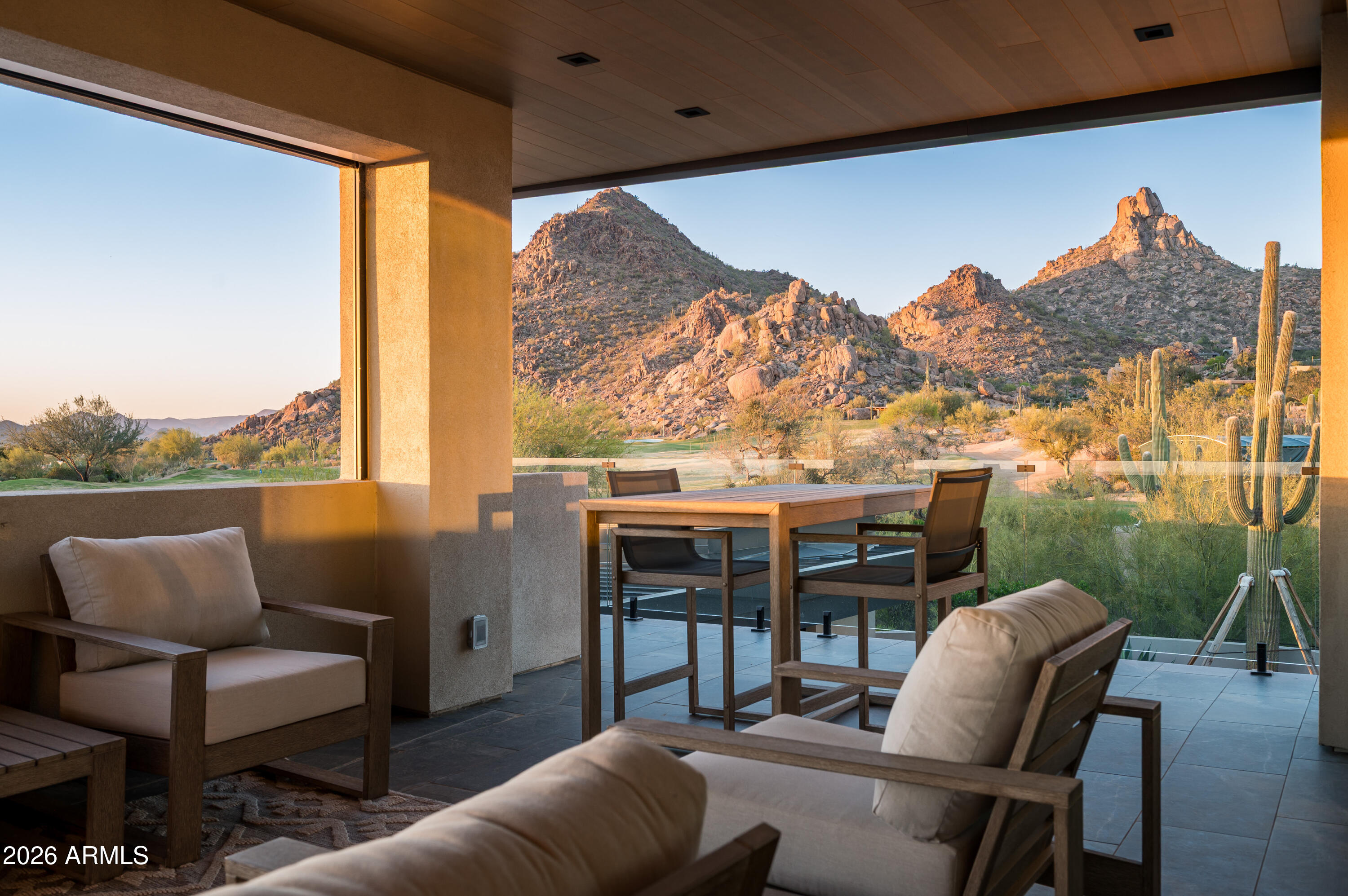 10040 East Happy Valley Road, Unit 13 Scottsdale, AZ 85255 - Photo 35 of 55 a balcony with furniture and a floor to ceiling window