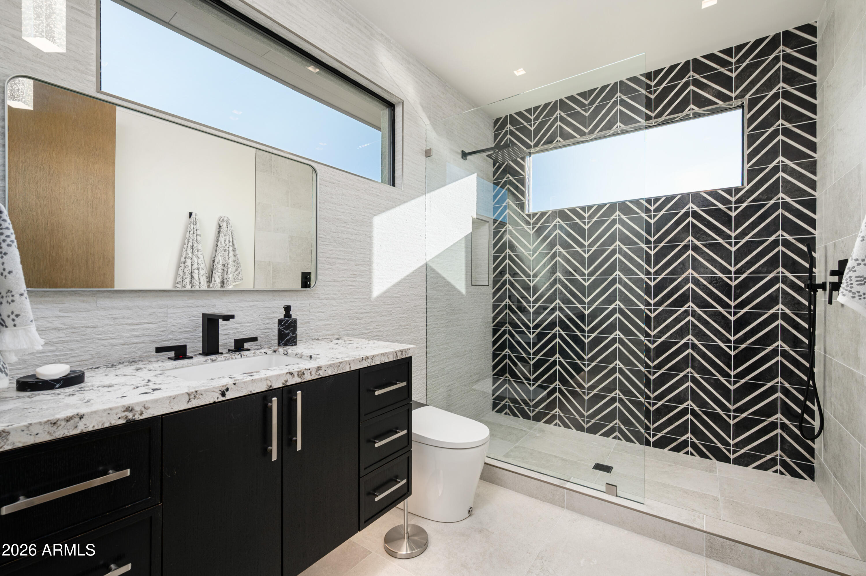 10040 East Happy Valley Road, Unit 13 Scottsdale, AZ 85255 - Photo 36 of 55 a bathroom with a sink and a mirror