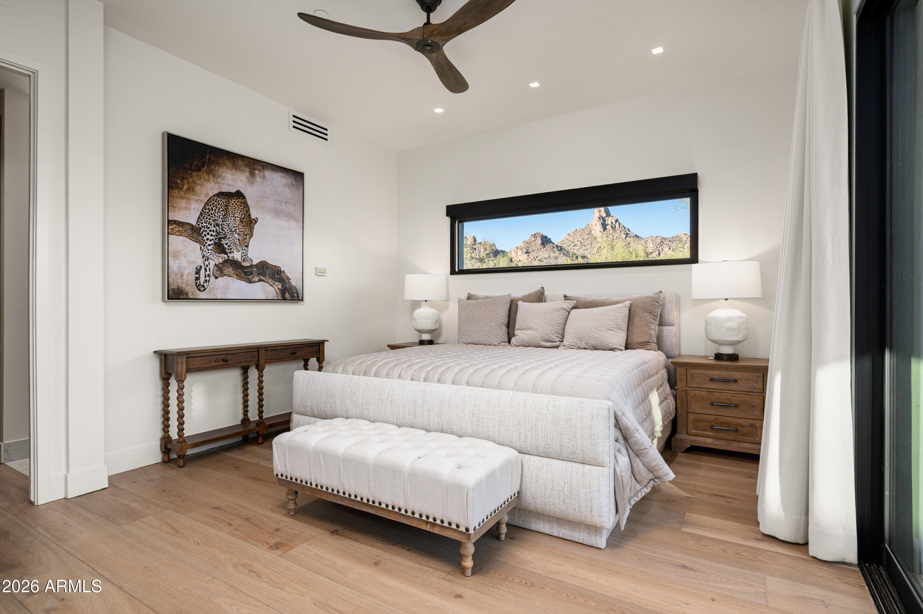 10040 East Happy Valley Road, Unit 13 Scottsdale, AZ 85255 - Photo 44 of 55 a bedroom with a bed and a painting on the wall