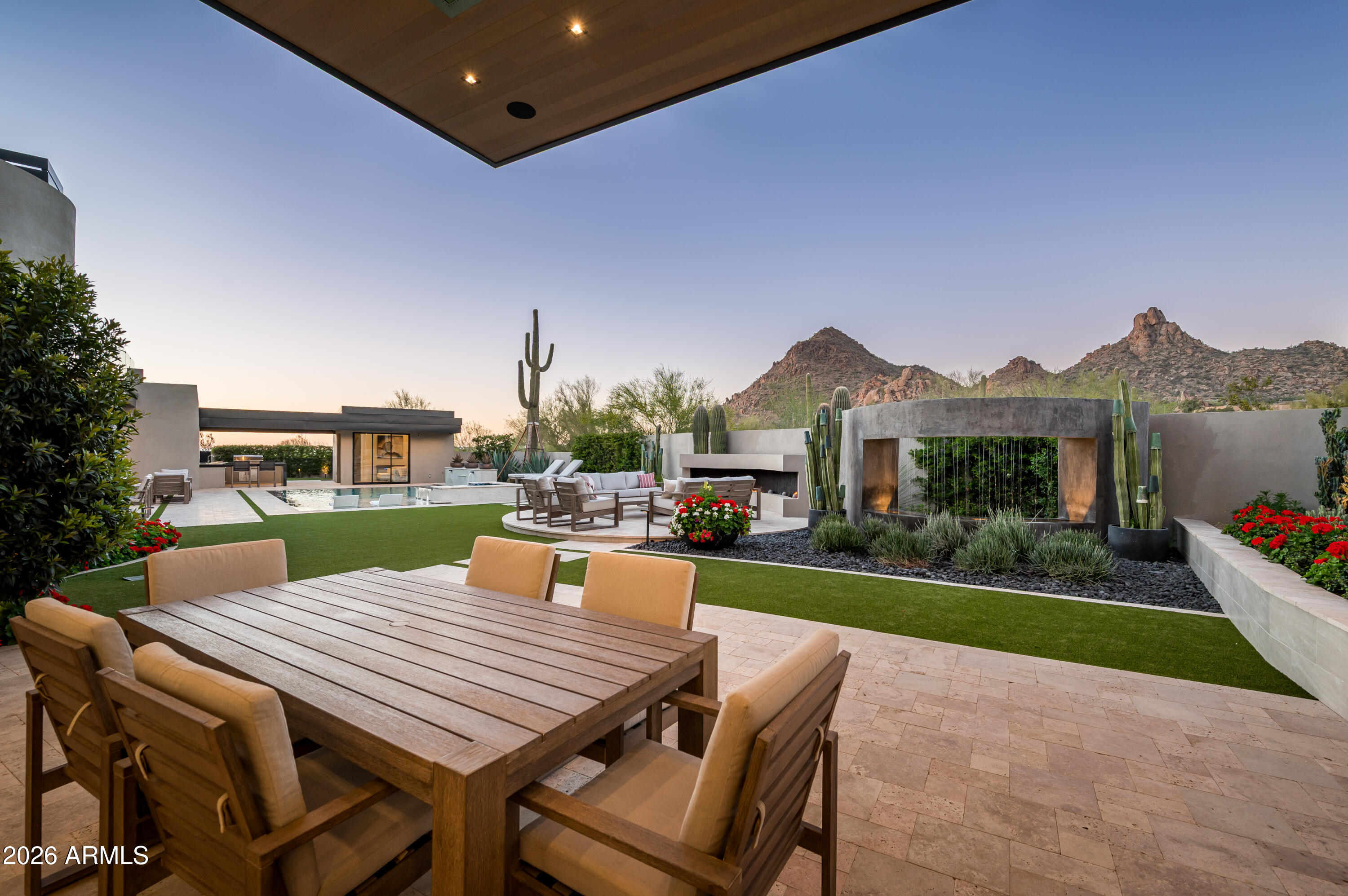 10040 East Happy Valley Road, Unit 13 Scottsdale, AZ 85255 - Photo 46 of 55 a view of a patio with table and chairs floor to ceiling window and a yard