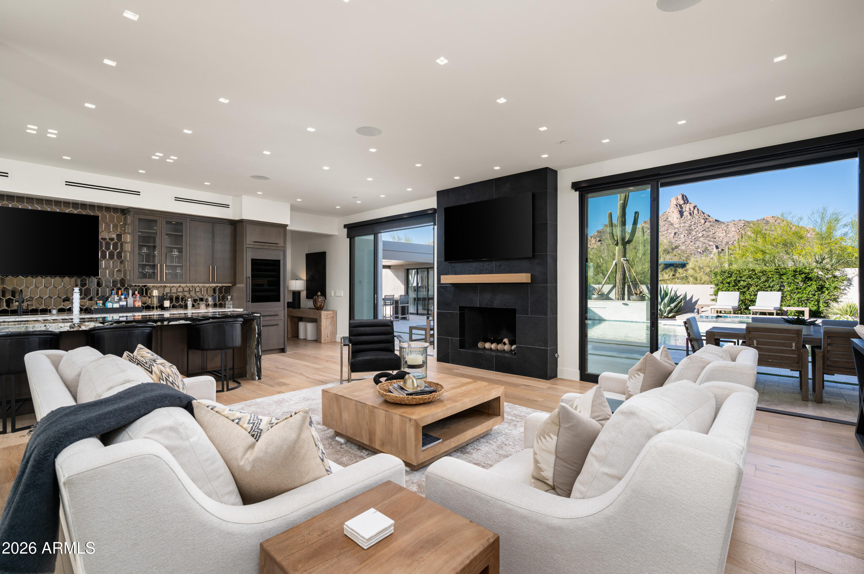 10040 East Happy Valley Road, Unit 13 Scottsdale, AZ 85255 - Photo 5 of 55 a living room with furniture fireplace and floor to ceiling windows