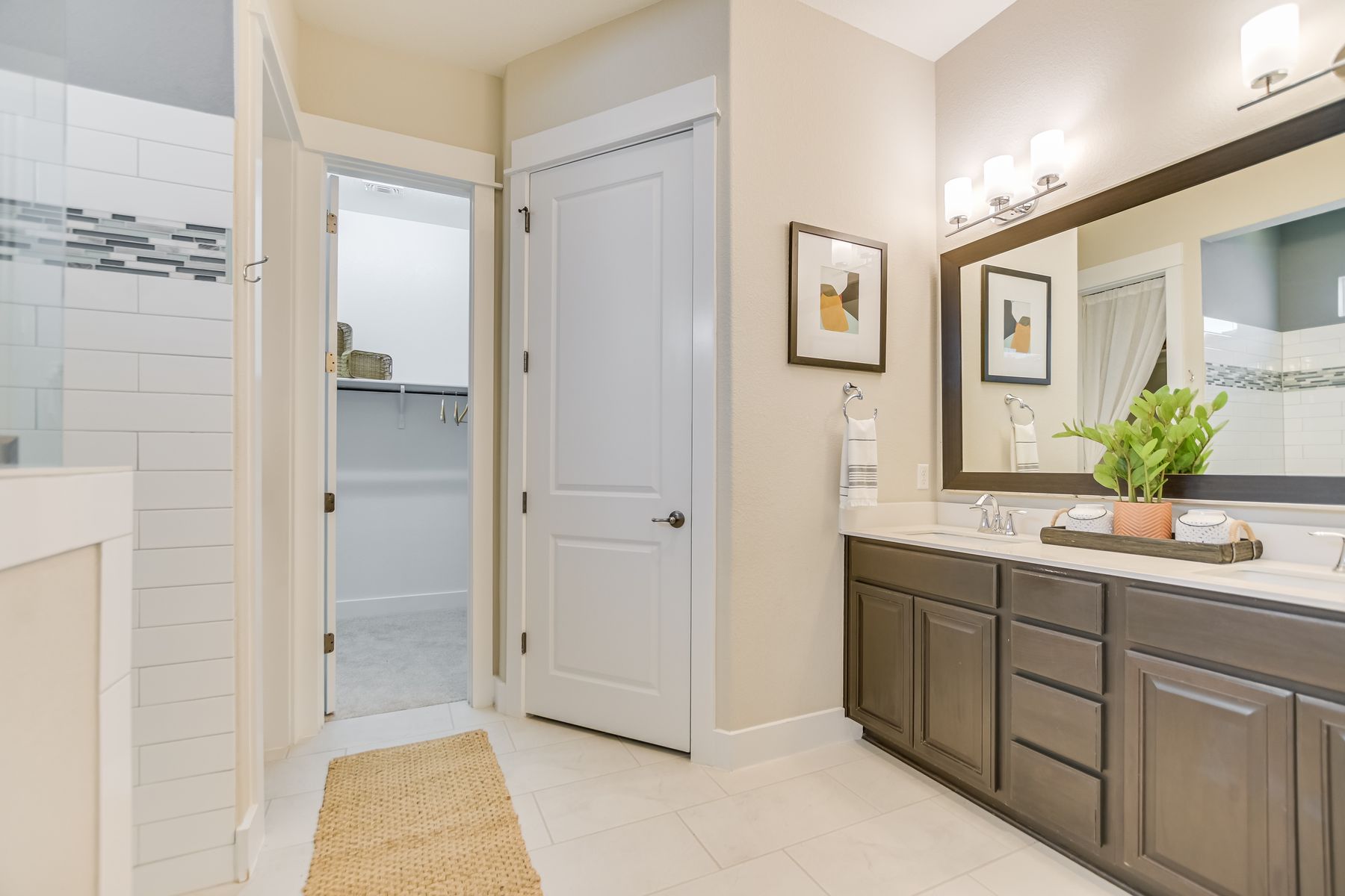 2405 Moreno Street Austin, TX 78723 - Photo 14 of 20 Spacious primary bath with a walk-in shower, double vanity, and generous walk-in closet.