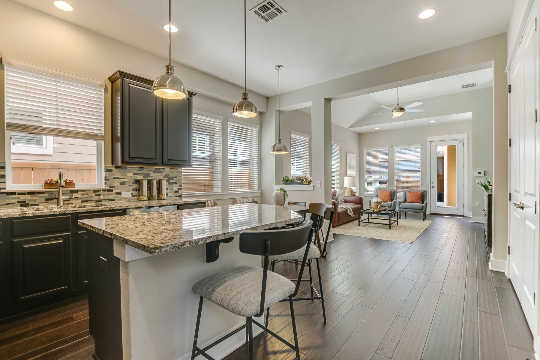 2405 Moreno Street Austin, TX 78723 - Photo 7 of 20 An inviting open plan seamlessly flows from the kitchen to the living room in the heart of the home.