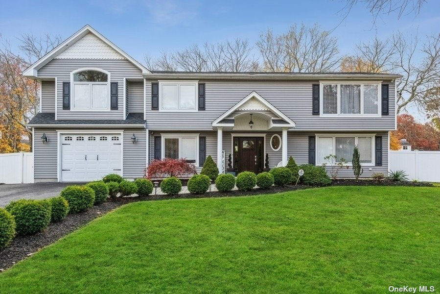 214 Beaver Dam Road Islip, NY 11751 - Photo 1 of 1 a front view of a house with a garden