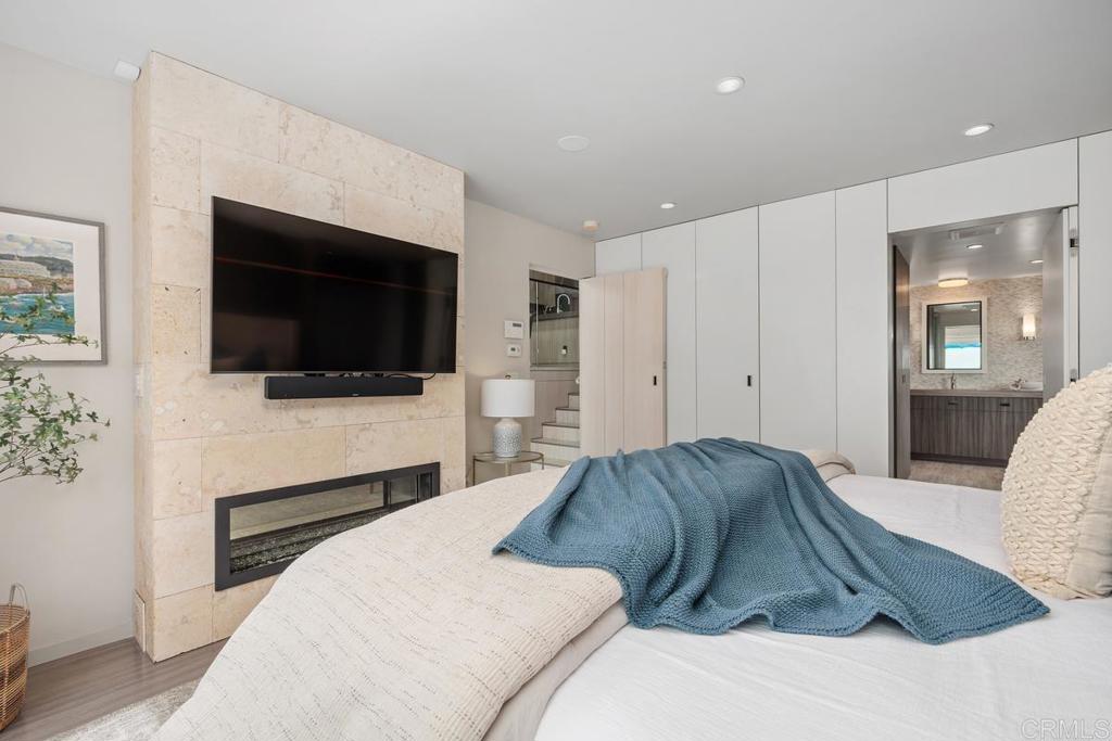 1856 Parliament Road Encinitas, CA 92024 - Photo 23 of 42 a bedroom with a bed and a flat screen tv
