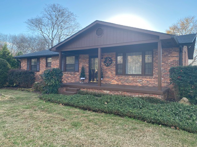 a front view of a house with yard and green space