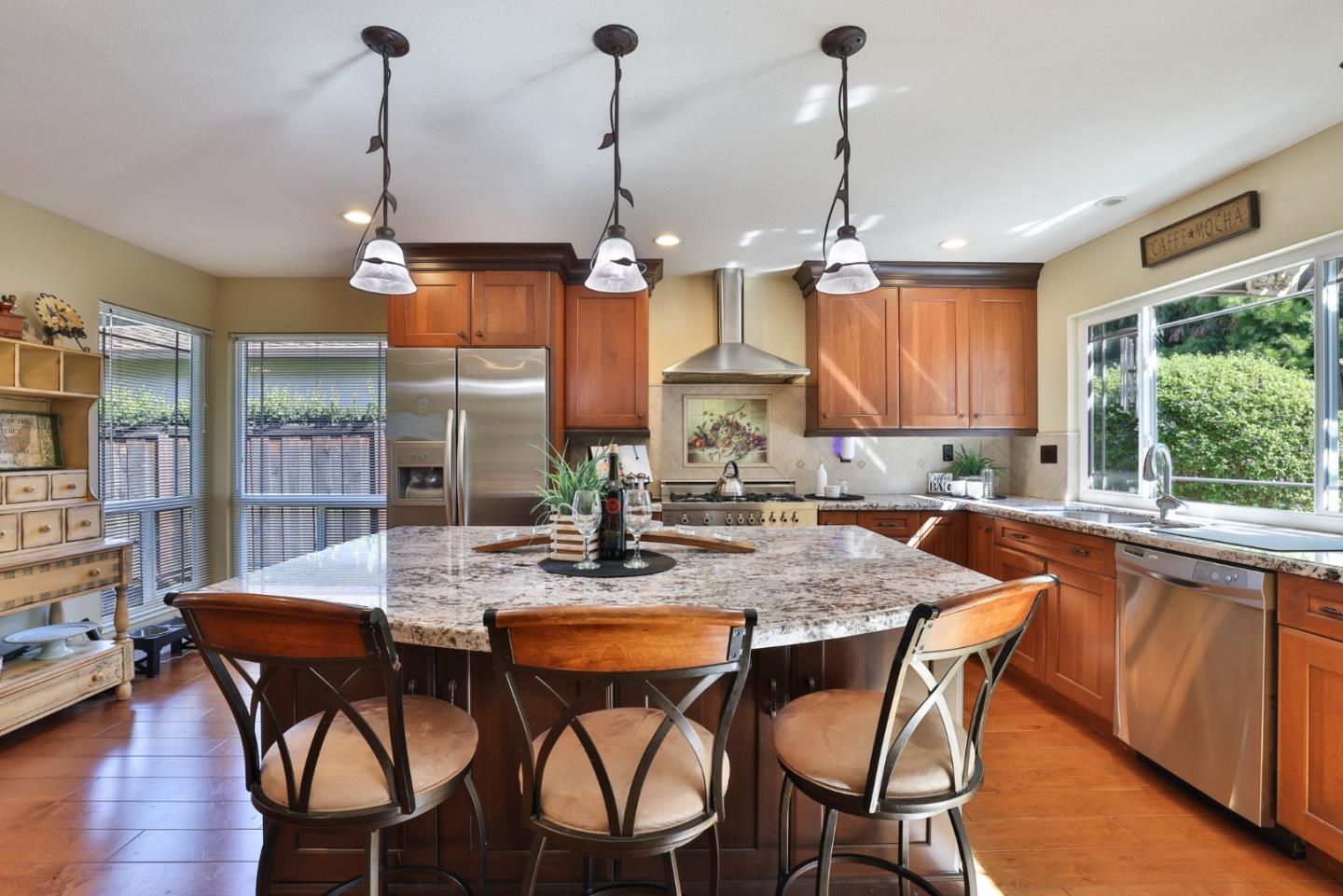 2314 Oak Flat Road San Jose, CA 95131 - Photo 11 of 36 a kitchen with stainless steel appliances granite countertop a kitchen island a stove a table and chairs