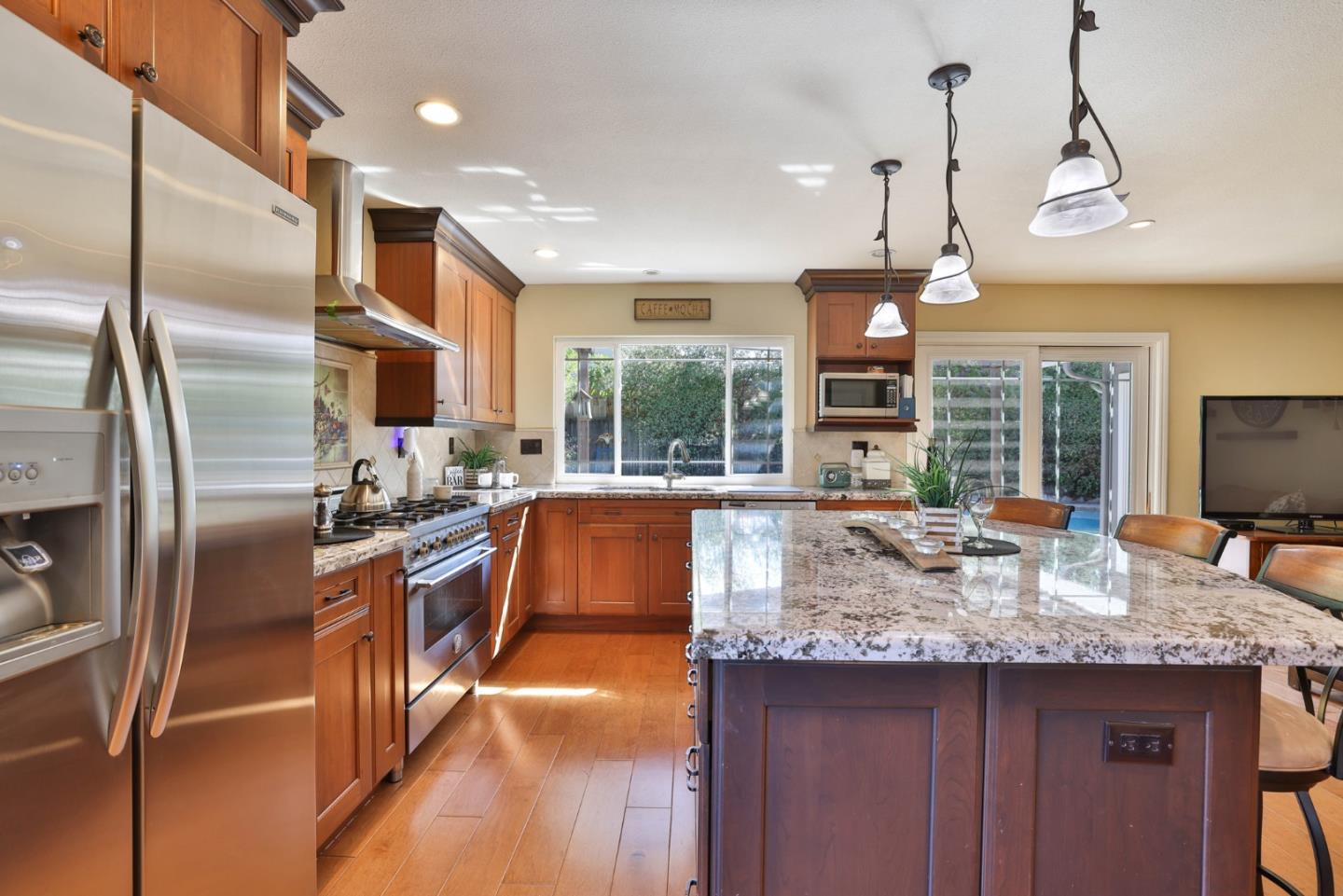 2314 Oak Flat Road San Jose, CA 95131 - Photo 12 of 36 a kitchen with stainless steel appliances granite countertop a sink a stove and a refrigerator