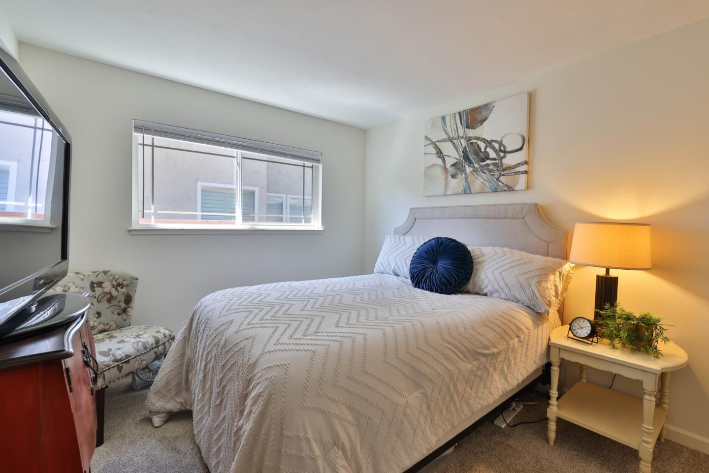 2314 Oak Flat Road San Jose, CA 95131 - Photo 16 of 36 a bedroom with a bed and a lamp