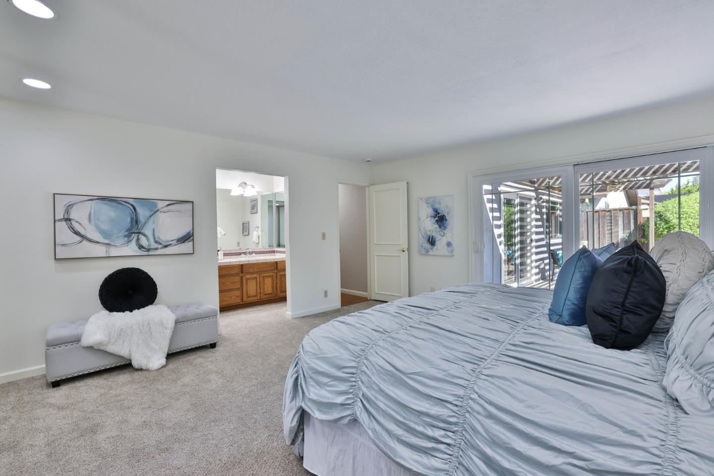 2314 Oak Flat Road San Jose, CA 95131 - Photo 20 of 36 a bedroom with a bed and a large mirror