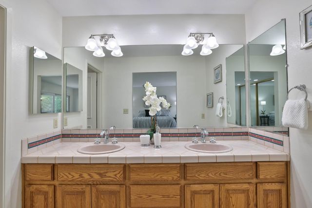 a bathroom with a sink double vanity and a mirror
