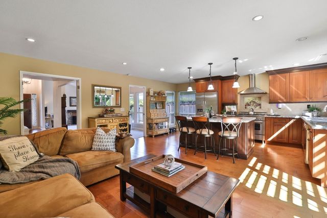 a living room with furniture kitchen and a table