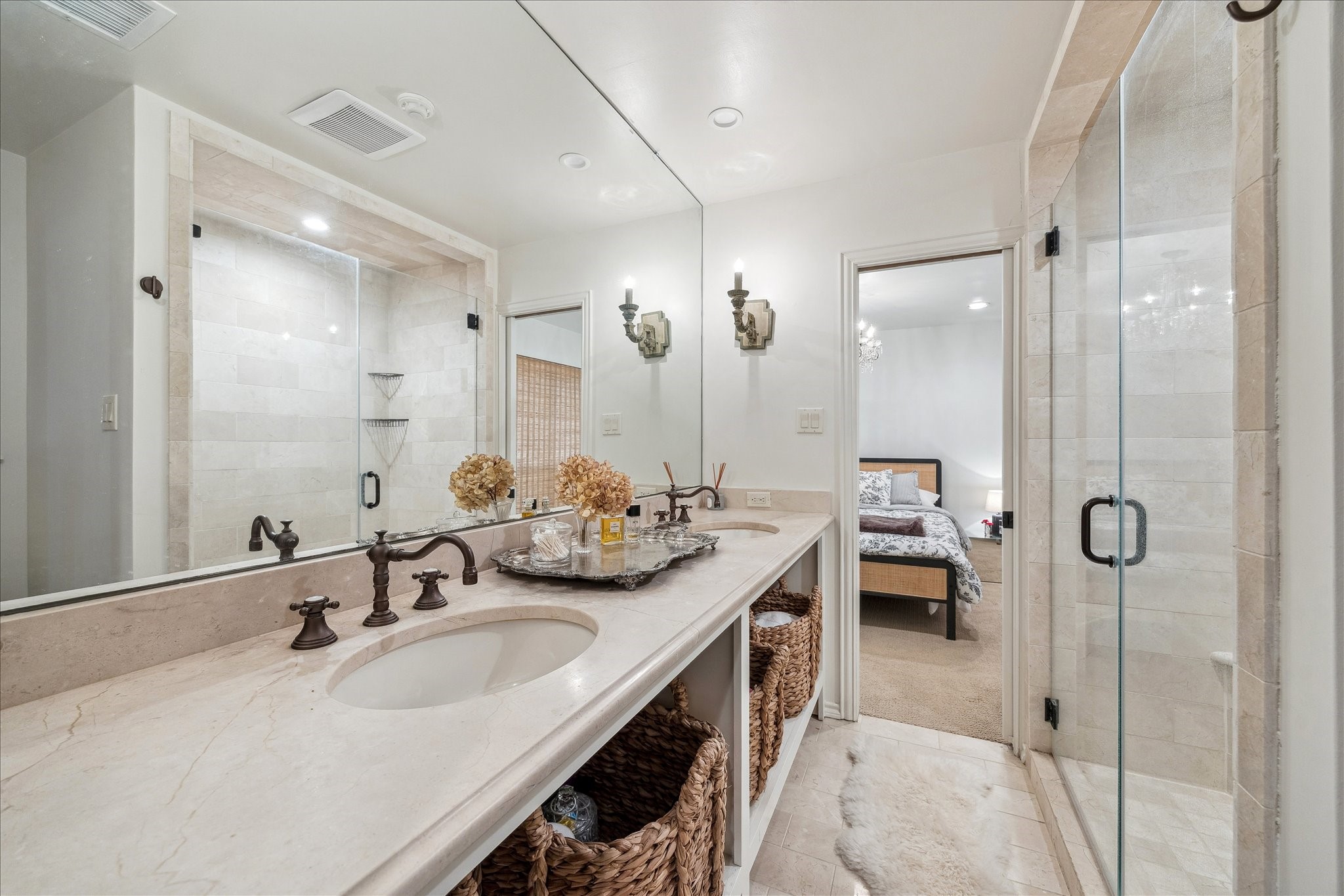230 Gessner Road Houston, TX 77024 - Photo 18 of 31 a en suite bathroom with a double vanity sink a mirror and shower