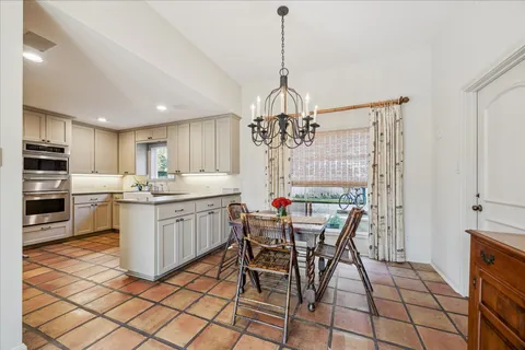 a kitchen with stainless steel appliances a stove sink and cabinets