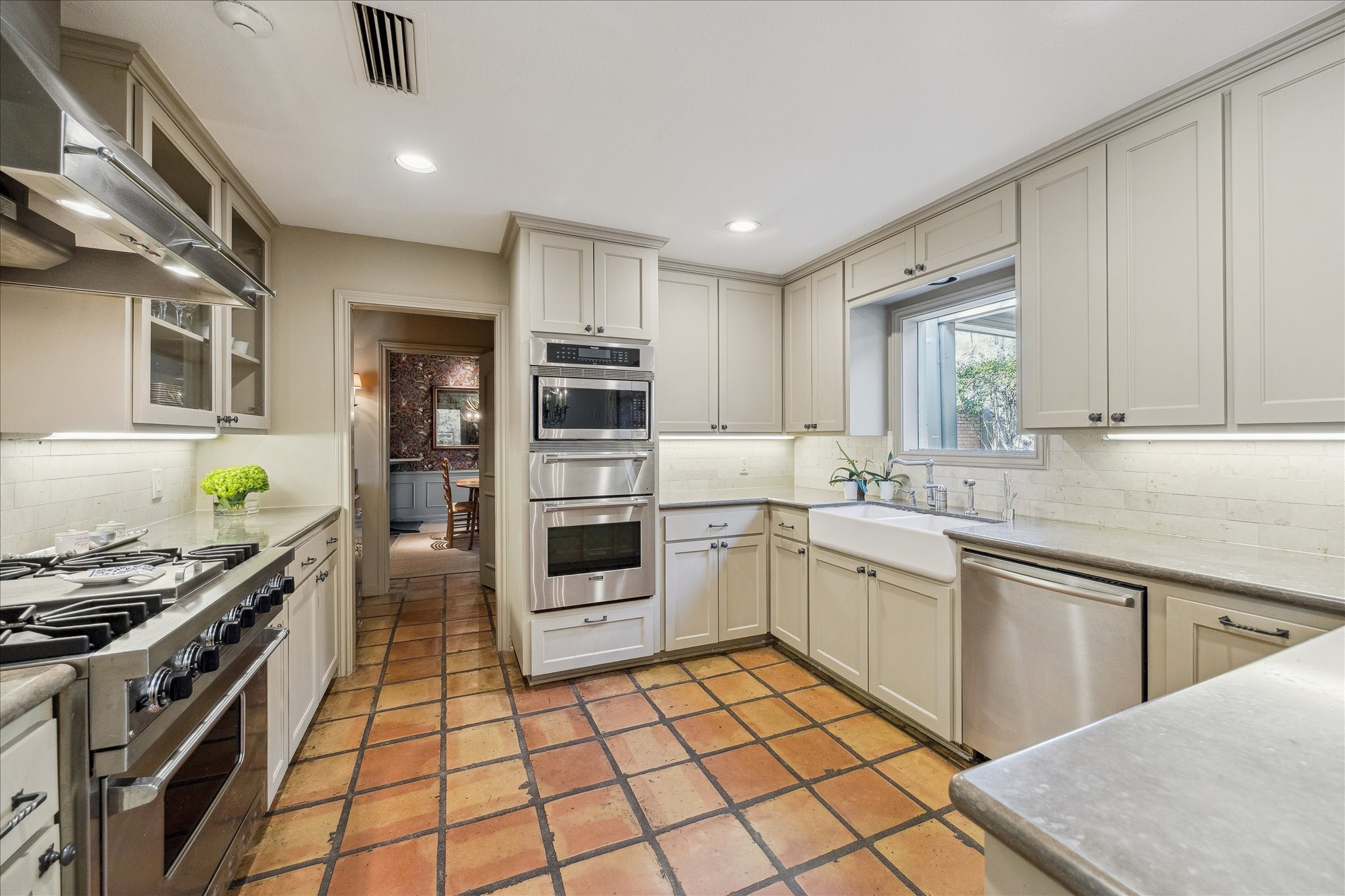 230 Gessner Road Houston, TX 77024 - Photo 10 of 31 a kitchen with stainless steel appliances a stove sink and cabinets