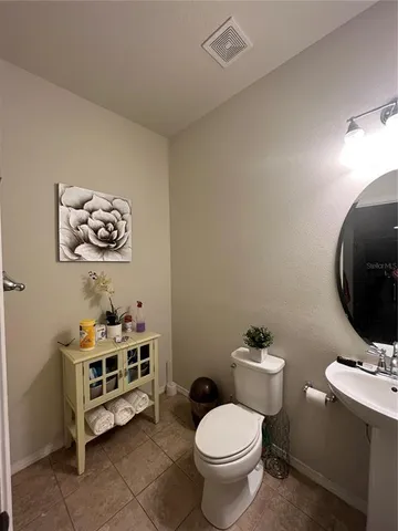 a bathroom with a toilet a sink and a mirror