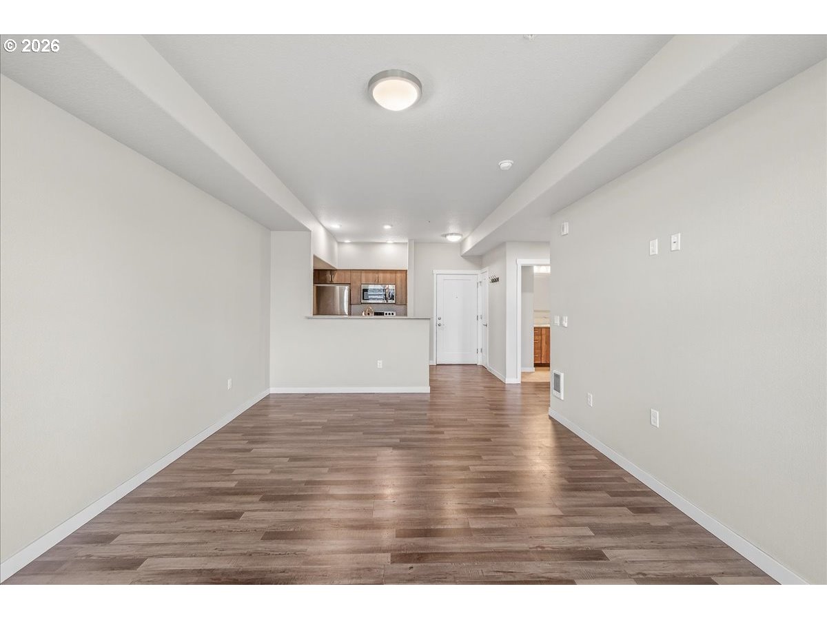 16401 Northwest Chadwick Way, Unit 108 Portland, OR 97229 - Photo 15 of 29 a view of an empty room with wooden floor