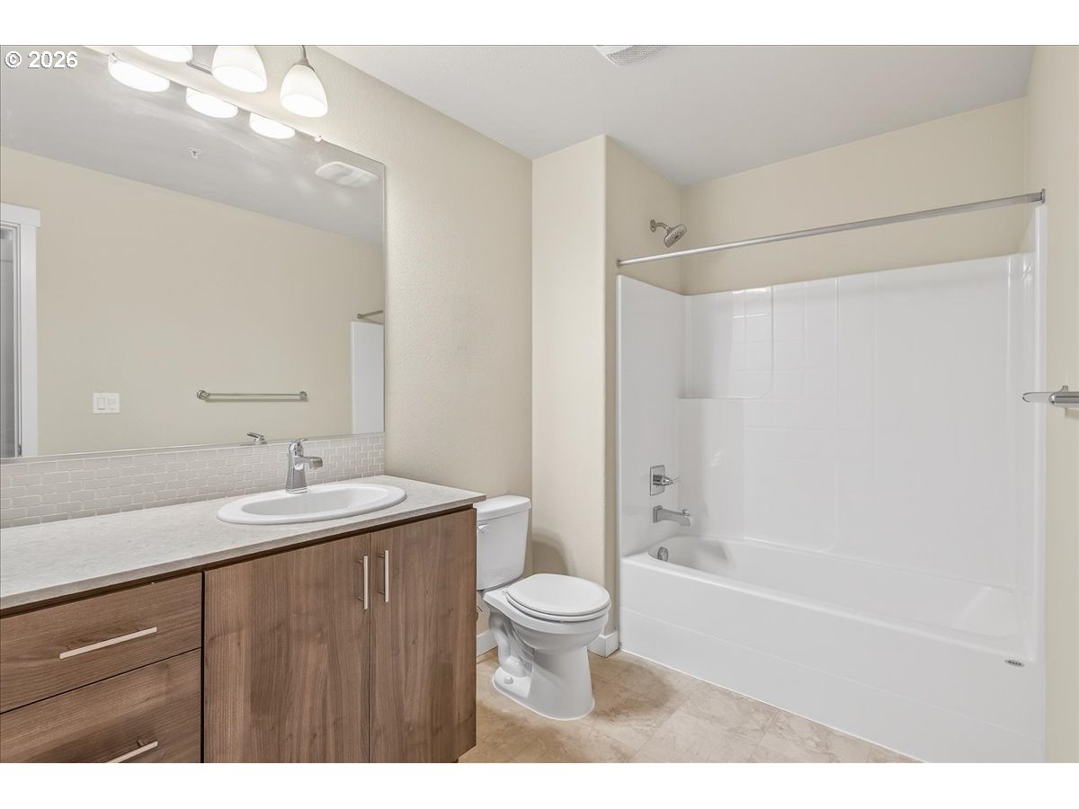 16401 Northwest Chadwick Way, Unit 108 Portland, OR 97229 - Photo 22 of 29 a bathroom with a sink a toilet and shower