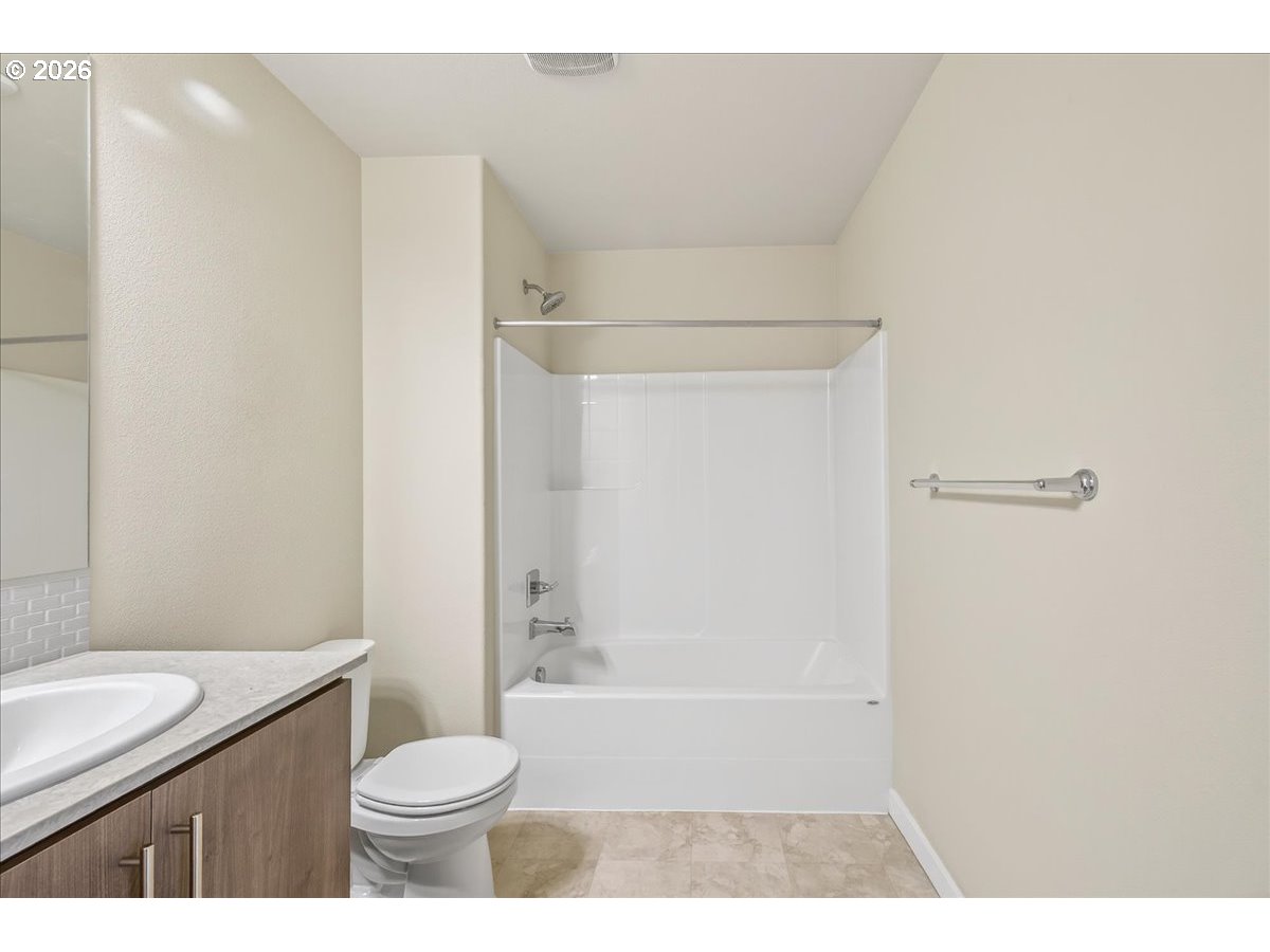 16401 Northwest Chadwick Way, Unit 108 Portland, OR 97229 - Photo 23 of 29 a bathroom with a sink a toilet and shower