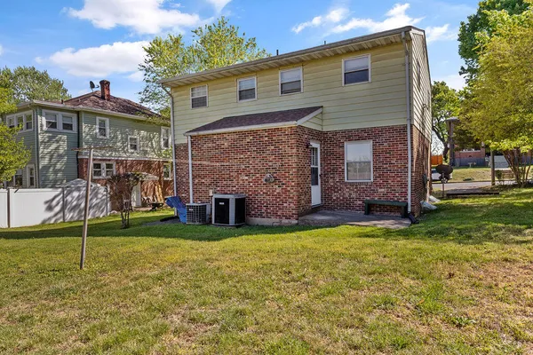 a view of a house with a yard and sitting area