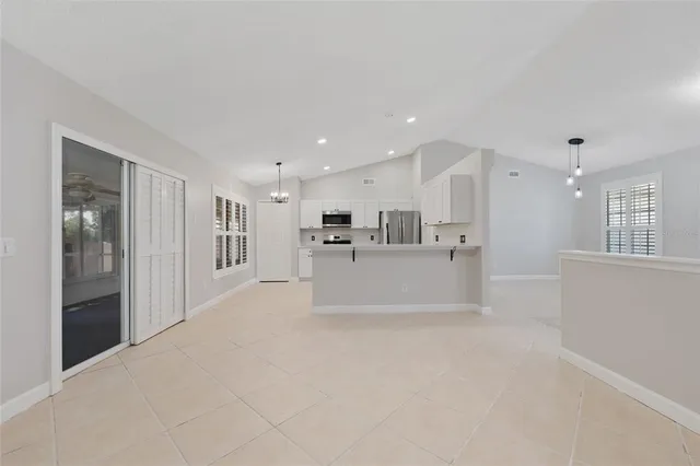a view of a kitchen with refrigerator and a sink