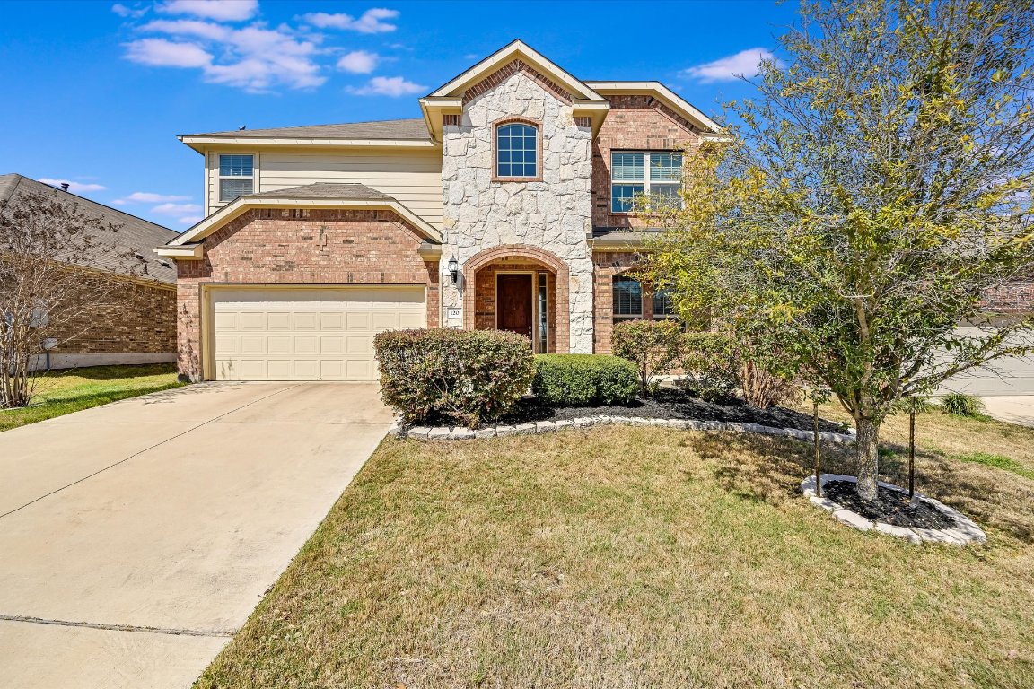 a front view of a house with a yard