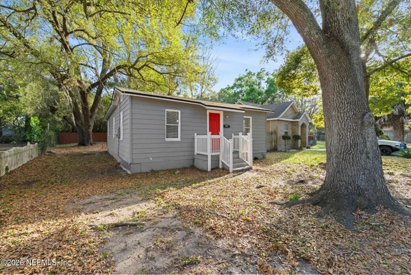 a view of a house with a tree in the background