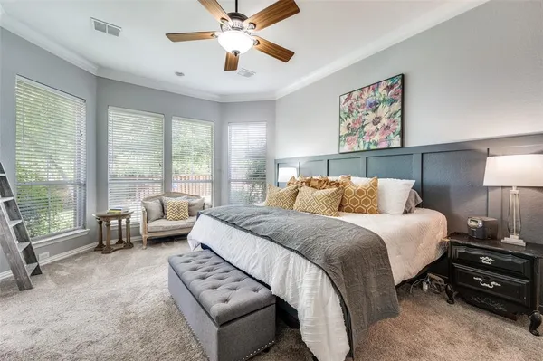a bedroom with bed and a large window