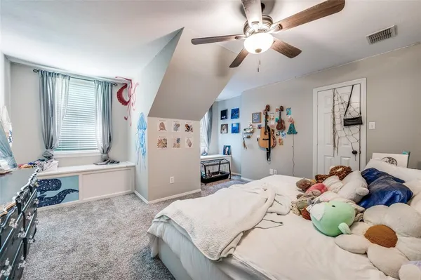 a bedroom with a bed and a large window