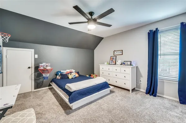 a bedroom with a bed and with furniture