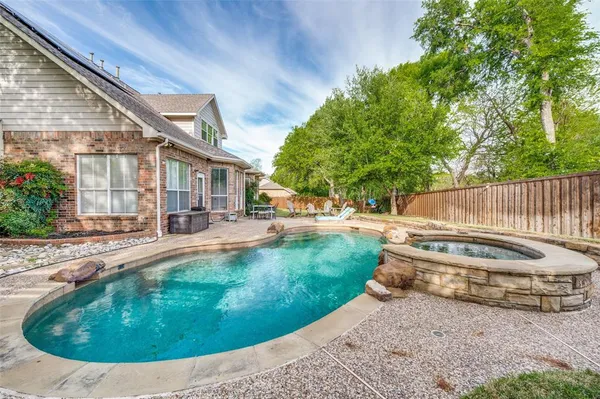 a view of a house with backyard and sitting area